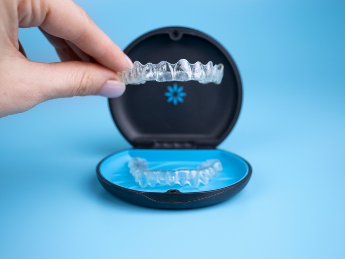 Taking Invisalign aligner out of its case
