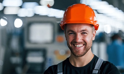 warehouse worker with a hard hat smiling
