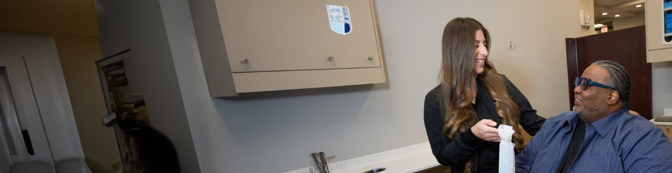 Dental patient looking up at dentist and smiling