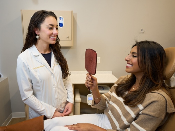 Female patient checking teeth after smile makeover in Wethersfield