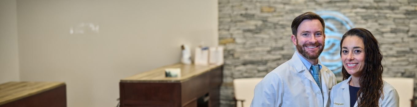 A dentist speaking with a patient over a video call.