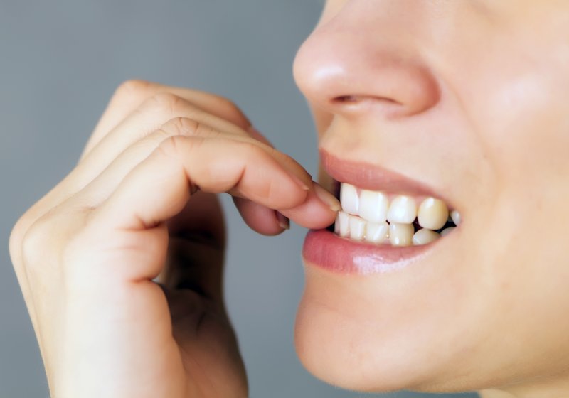 Woman biting nails