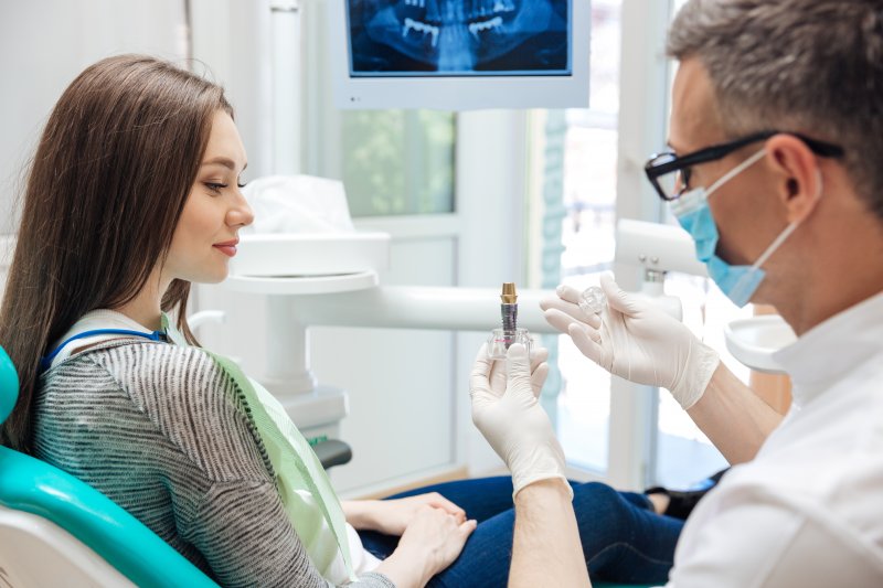 A dentist about to perform dental implant surgery on a patient