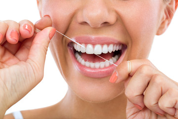person flossing with dental implants