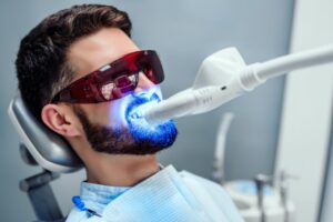 Man getting a professional teeth whitening treatment