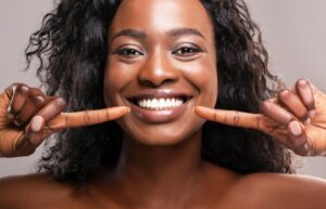 Woman smiling wide after cosmetic dental treatment