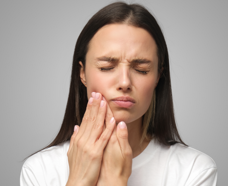 Woman holding jaw in pain