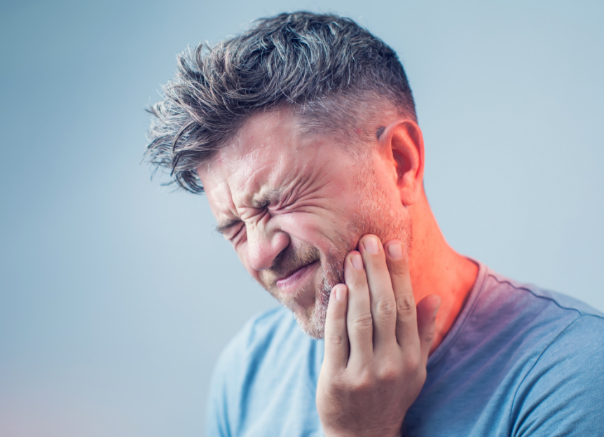 Man holding jaw in pain